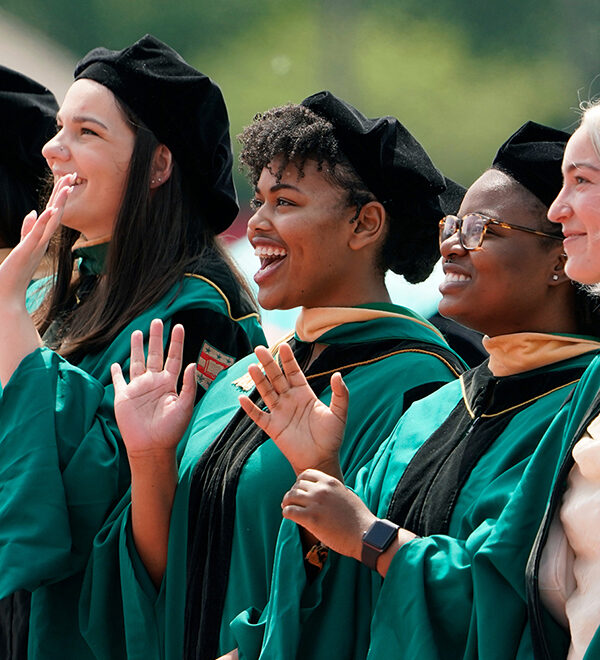 WashU grads clapping at 2022 Commencement