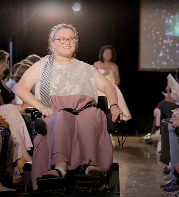 girl in a wheelchair wearing clothing designed for her by washu student designers