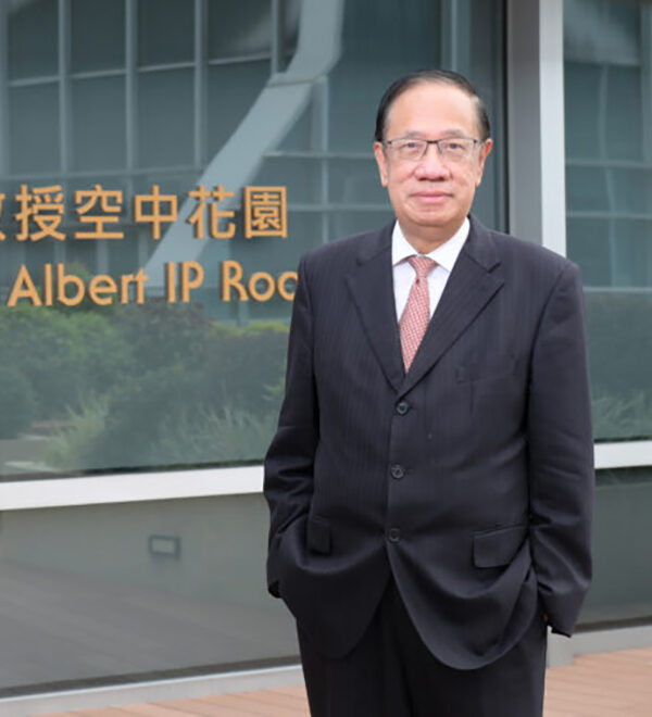 Albert Ip standing in front of a sign with his name on it