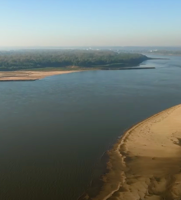 Aerial view of Mississippi River with sand dunes on either side of frame